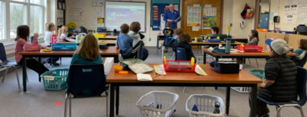 Featured image of article: Mr. Pimental reads to Miss Ambrosini’s class